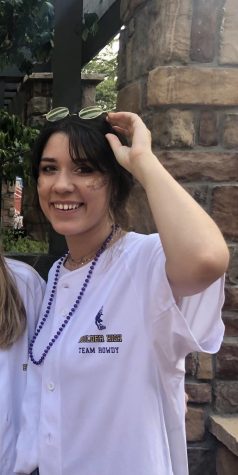 Ana wearing her jersey and purple and gold beads.