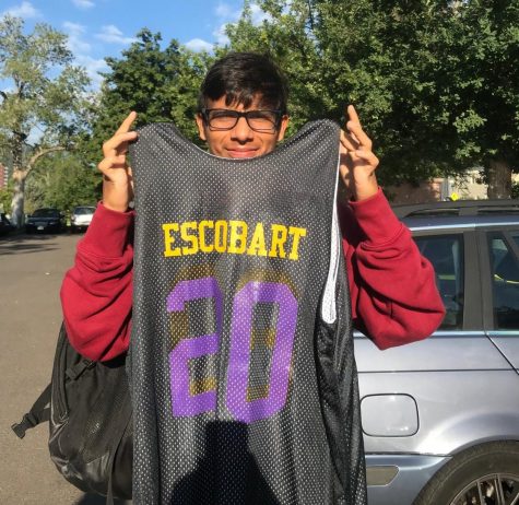 Saul holds up his "ESCOBART" jersey in the senior lot.