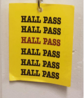 A photograph of a yellow hall pass