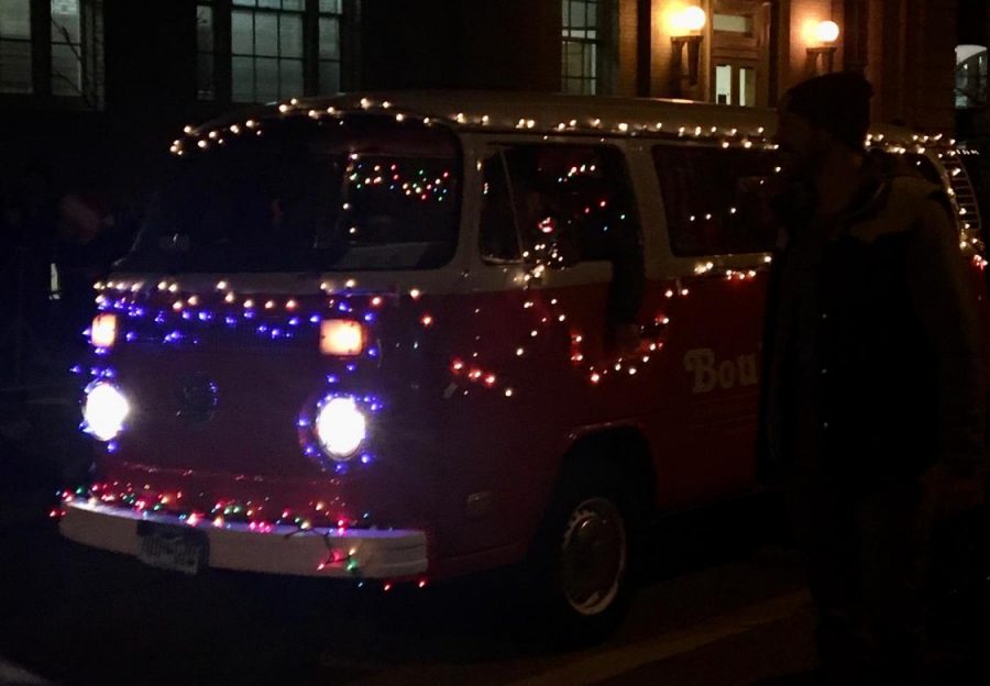 A Boulder business promotes itself via a string-light-bedazzled van which drove during the parade.