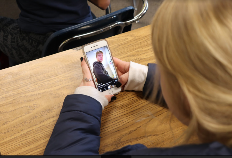 Former staff member Brenna Wright watches Tik Tok on her phone in class. Photo by Cate Landry. 