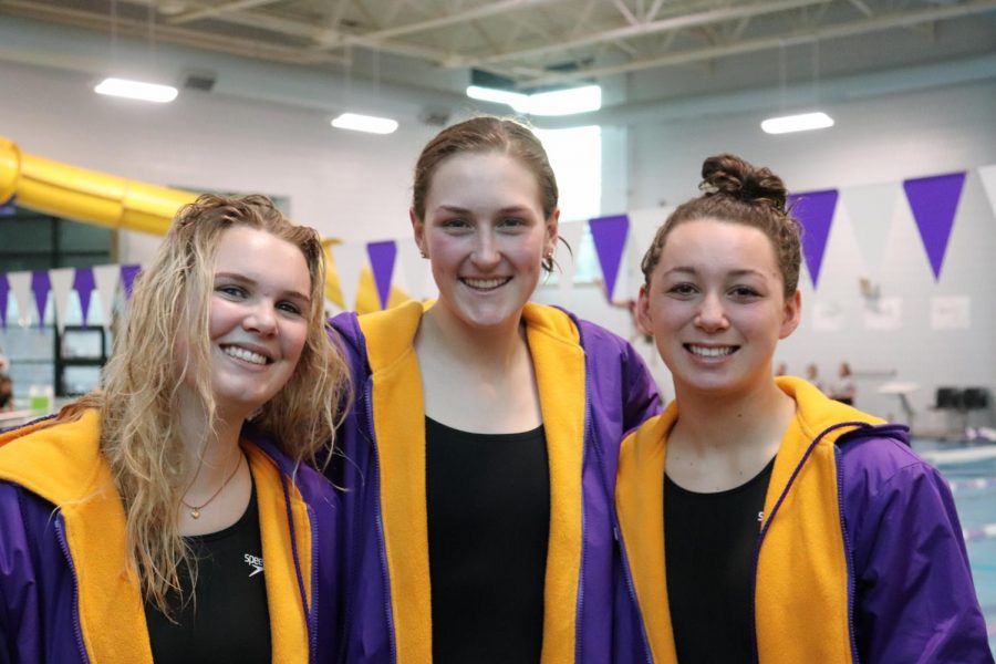 Swim+team+captains+and+seniors+Olivia+Normandeau%2C+Ella+Johnson%2C+and+Emilia+Culberson+smile+for+a+photo+after+a+successful+meet.+