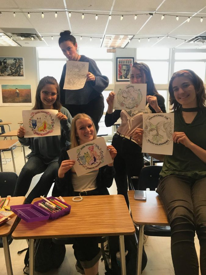 Amaya Brooks, junior, Lili Stevens, Rory Mendelow Sara Proctor and Ellory Boyd, seniors, posed with pictures they colored during the first Student Alliance for Consent and Sexual Safety meeting.