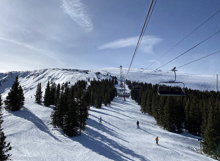 Skiers+cruise+down+the+slopes+at+Crested+Butte+Mountain+Resort.+