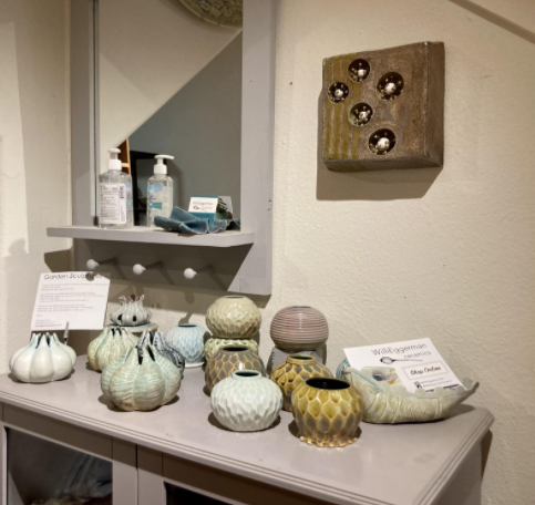 A display of pottery along with hand sanitizer in Willi Eggermans studio.