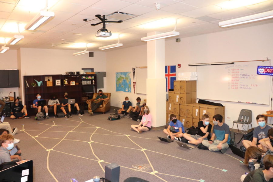 Students sit on the floor, disappointed that they have no furniture. Luckily, Mrs. Zimmerman is a creative and flexible teacher. 
