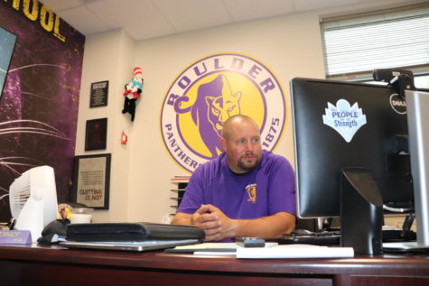 Bishop looks over the fall sports schedule with extreme care, making sure there are no errors. 