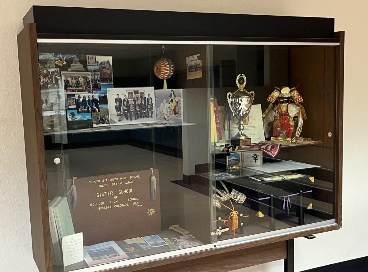 Sister school Jitsugyo High's display case stands strong between the business and social studies hallways. The case proudly shows items of culture, connection, and trophies.