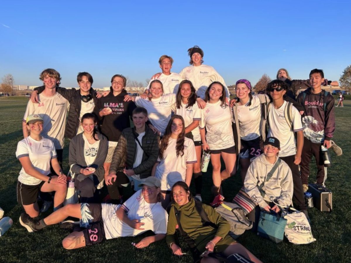 Sterling Hammer-Cadora, '26, and her team posing after an overtime victory against a Denver team in the 2024 season.