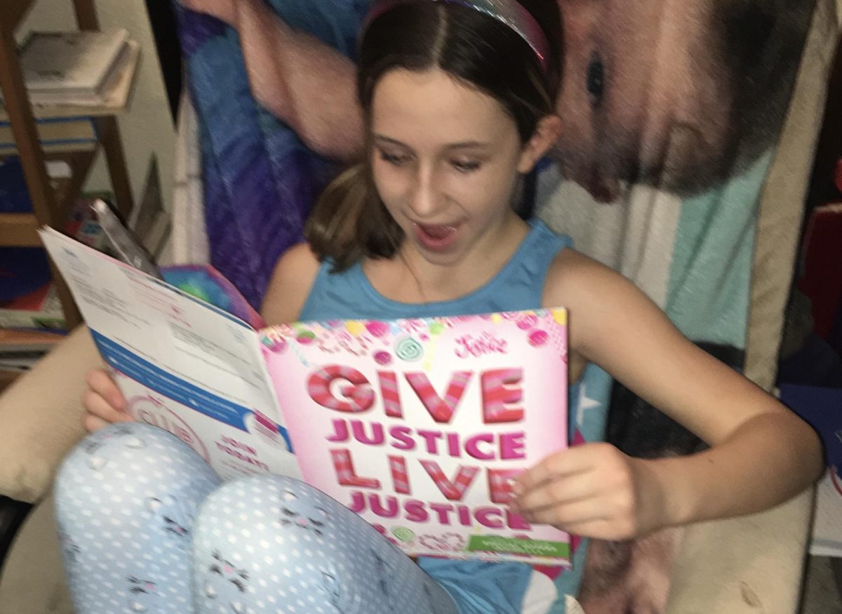 Tween Madison Sanford, ‘26, reads her mail catalog Justice magazine in 2017, with extreme joy and excitement!